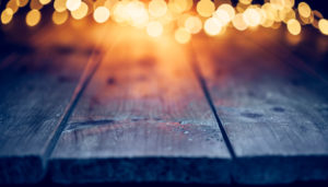 Defocused Christmas lights on old empty table.